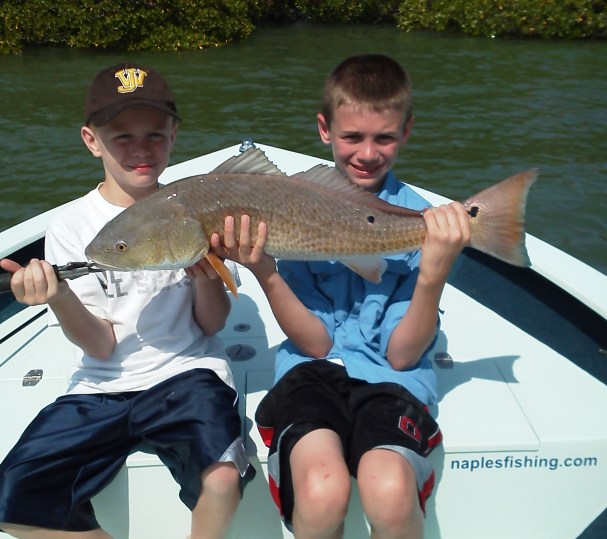 It takes two to handle this big fall redfish!