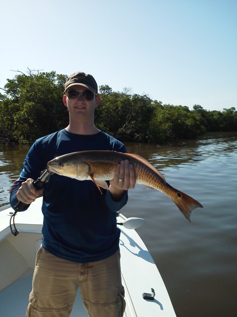Navy PO Eric Miller with one of many reds caught during the Naples Take a Soldier Fishing Tournament Sept. 2013