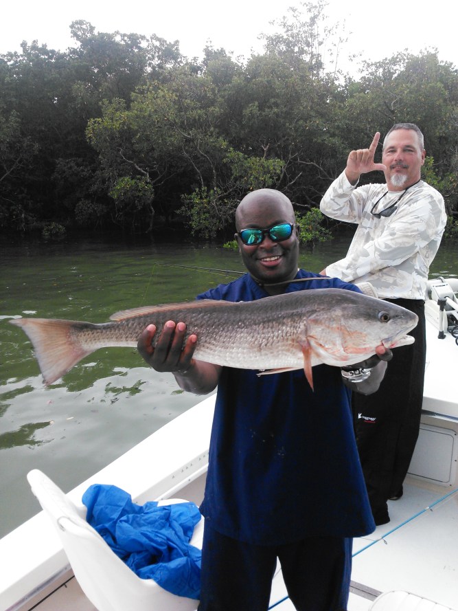 USAF M.Sgt Art Lindon hold up a big over slot redfish released during the 2015 Take A Soldier Fishing tournament last weekend. Sgt. 1st class Mark Miller is in the background. 